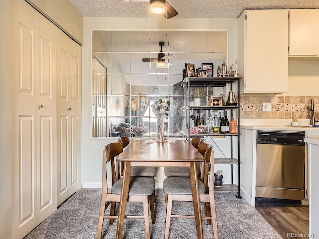 carpeted dining area with ceiling fan and a textured ceiling