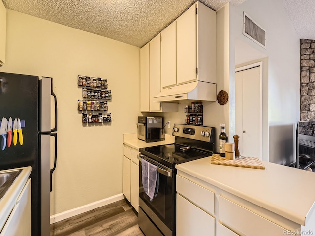 kitchen featuring white cabinets, stainless steel range with electric cooktop, a textured ceiling, refrigerator, and dark hardwood / wood-style floors