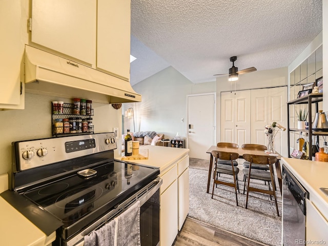 kitchen with ceiling fan, a textured ceiling, appliances with stainless steel finishes, and light hardwood / wood-style flooring