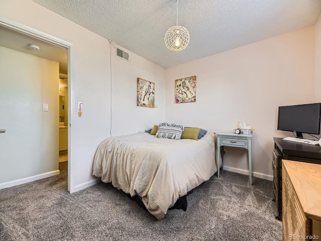 carpeted bedroom featuring a textured ceiling