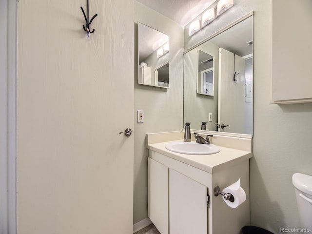 bathroom with vanity and toilet