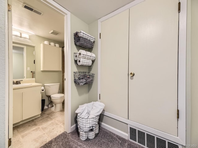 bathroom with toilet and vanity