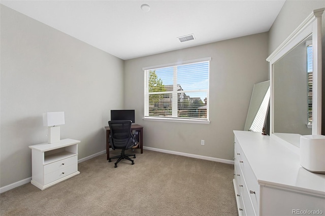 office space featuring visible vents, baseboards, and light carpet