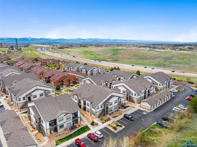 birds eye view of property featuring a mountain view and a residential view