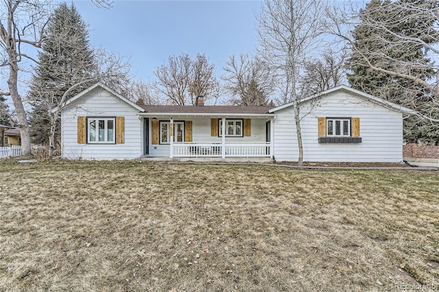 single story home featuring covered porch and a front yard