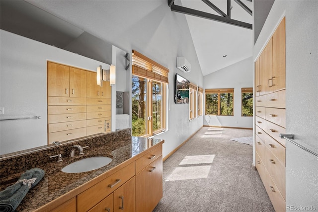 bathroom with vanity, high vaulted ceiling, and an AC wall unit