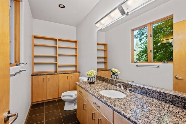 bathroom featuring tile patterned flooring, vanity, and toilet