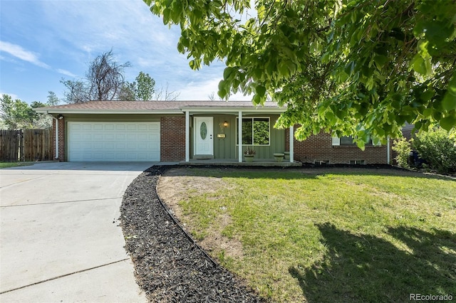 2120 S Ouray St, Aurora, CO 80013 - ranch-style house featuring an attached garage, board and batten siding, concrete driveway, brick siding, and covered porch