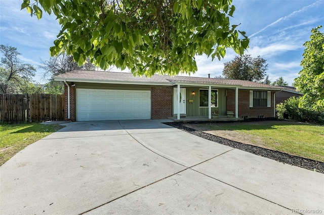 2120 S Ouray St, Aurora, CO 80013 - ranch-style home featuring brick siding, an attached garage, driveway, and a porch