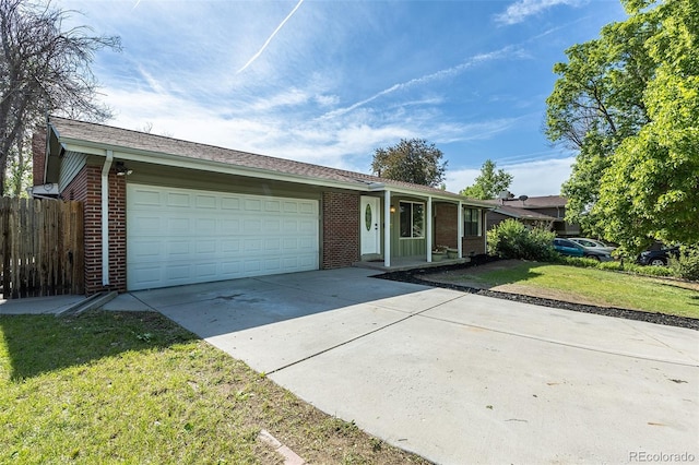 2120 S Ouray St, Aurora, CO 80013 - ranch-style home with brick siding, driveway, and an attached garage