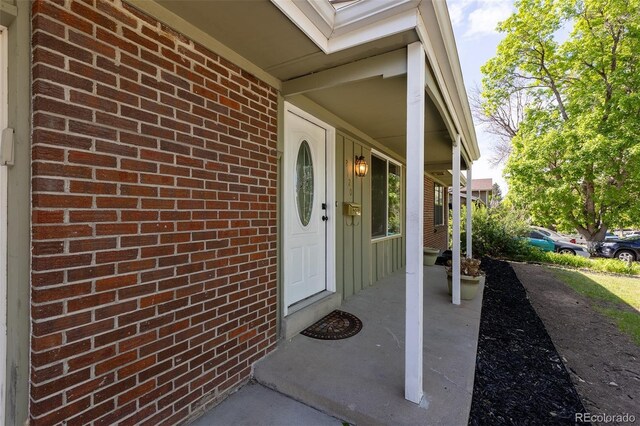2120 S Ouray St, Aurora, CO 80013 - view of exterior entry with brick siding and a porch