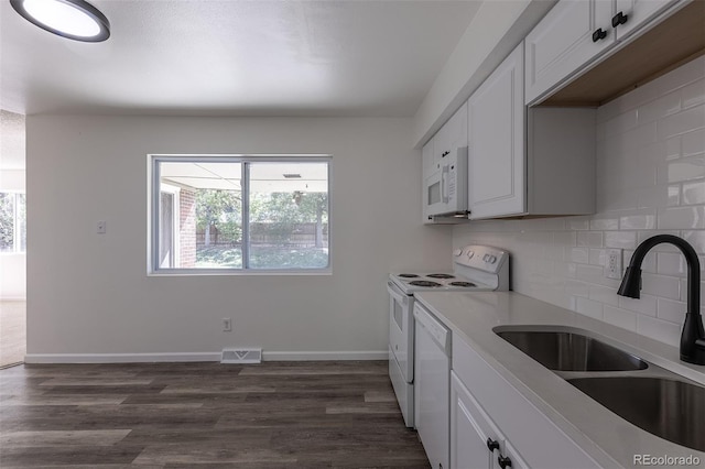 2120 S Ouray St, Aurora, CO 80013 - kitchen featuring a sink, white appliances, plenty of natural light, and backsplash