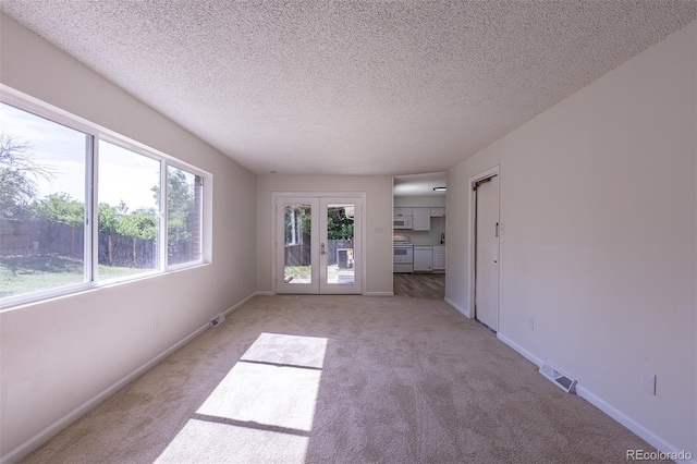 2120 S Ouray St, Aurora, CO 80013 - spare room featuring light carpet, a textured ceiling, and baseboards