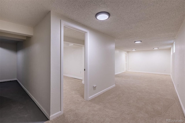 2120 S Ouray St, Aurora, CO 80013 - corridor with carpet floors, a textured ceiling, and baseboards