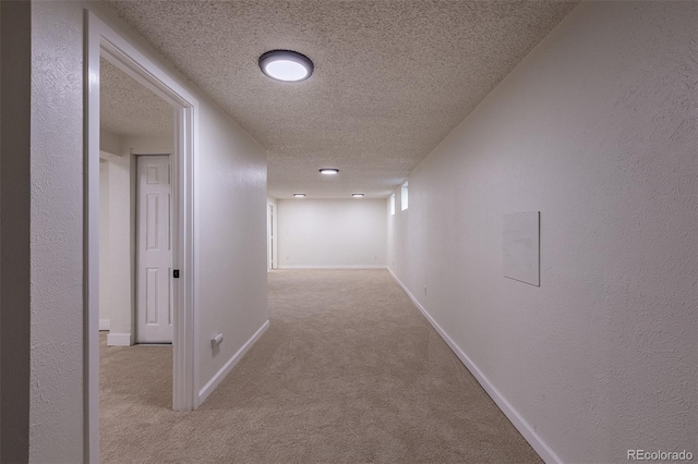 2120 S Ouray St, Aurora, CO 80013 - hall with a textured ceiling, carpet flooring, and baseboards