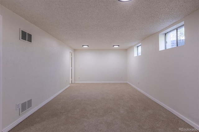 2120 S Ouray St, Aurora, CO 80013 - empty room featuring a textured ceiling, carpet floors, and baseboards