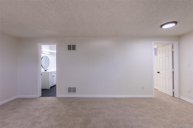 2120 S Ouray St, Aurora, CO 80013 - carpeted spare room featuring baseboards and a textured ceiling