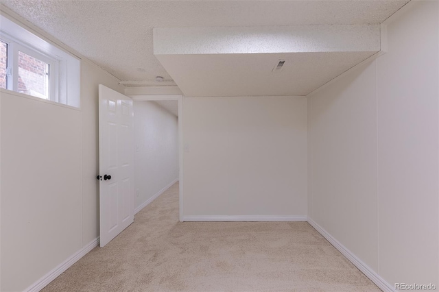 2120 S Ouray St, Aurora, CO 80013 - basement featuring carpet flooring, a textured ceiling, and baseboards