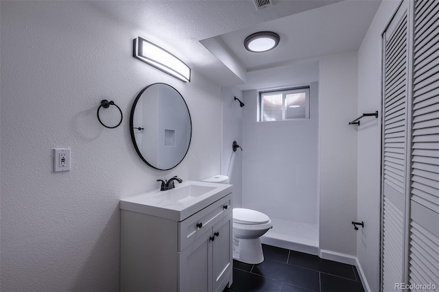 2120 S Ouray St, Aurora, CO 80013 - full bathroom featuring a closet, toilet, tile patterned floors, tiled shower, and vanity