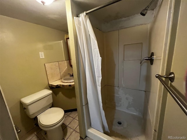 bathroom with walk in shower, sink, toilet, and tile patterned flooring