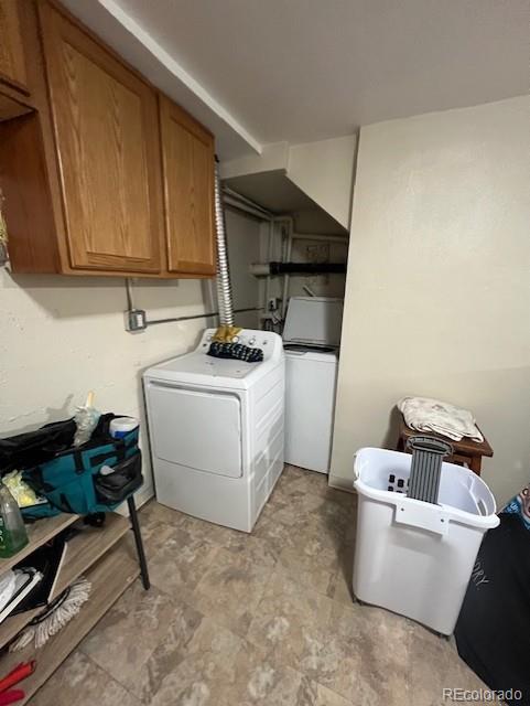 laundry area with washer / dryer and cabinets