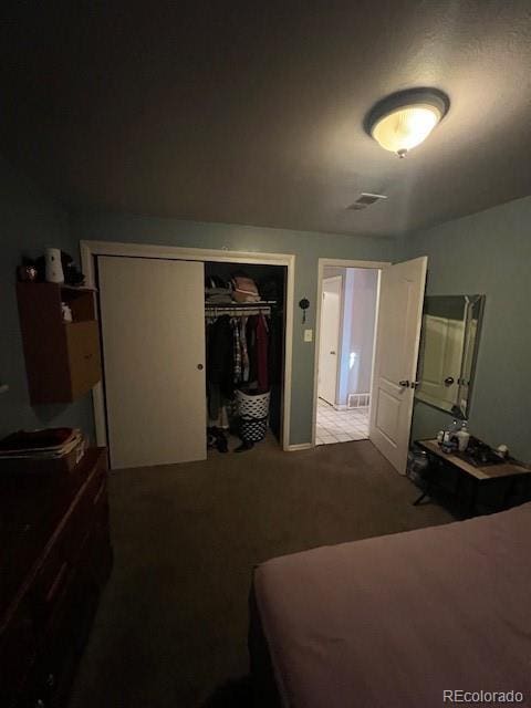 carpeted bedroom with a closet