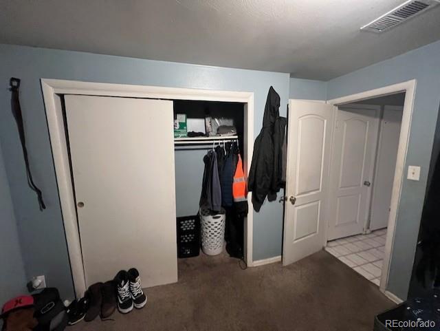 bedroom with light colored carpet and a closet