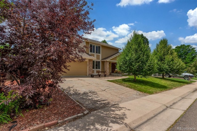 7762 W Ottawa Pl, Littleton, CO 80128 - obstructed view of property featuring driveway, a front lawn, and brick siding