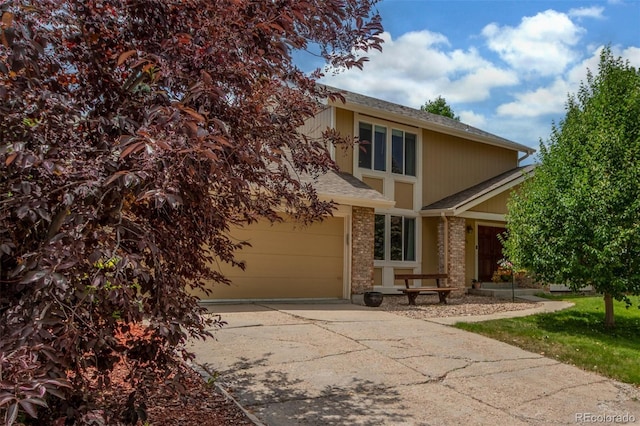 7762 W Ottawa Pl, Littleton, CO 80128 - view of front of house with driveway, a shingled roof, and brick siding