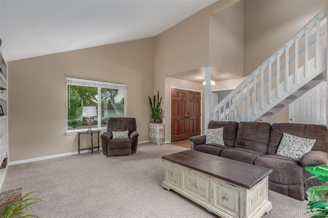 7762 W Ottawa Pl, Littleton, CO 80128 - living room with stairs, high vaulted ceiling, and light carpet