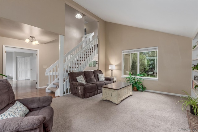7762 W Ottawa Pl, Littleton, CO 80128 - carpeted living area featuring high vaulted ceiling, stairway, and a chandelier