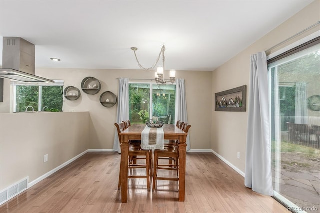 7762 W Ottawa Pl, Littleton, CO 80128 - dining area featuring a chandelier and light wood finished floors