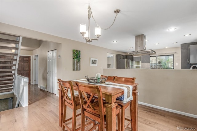 7762 W Ottawa Pl, Littleton, CO 80128 - dining space with wood finished floors, a chandelier, and recessed lighting