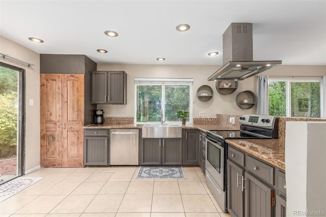 7762 W Ottawa Pl, Littleton, CO 80128 - kitchen featuring appliances with stainless steel finishes, island exhaust hood, light stone counters, recessed lighting, and light tile patterned floors
