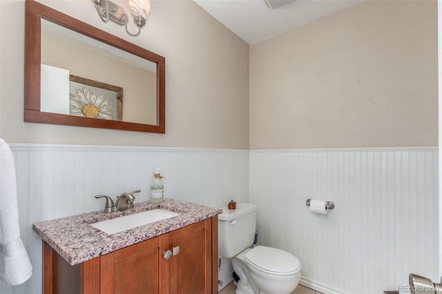 7762 W Ottawa Pl, Littleton, CO 80128 - bathroom with a wainscoted wall and vanity