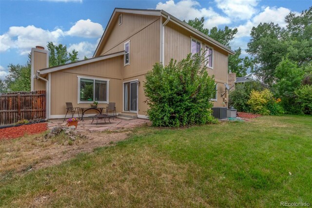 7762 W Ottawa Pl, Littleton, CO 80128 - rear view of house with a chimney and a patio area