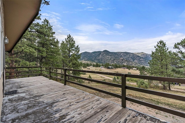 wooden deck with a mountain view