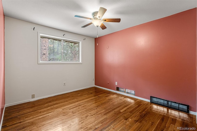 spare room featuring wood-type flooring and ceiling fan