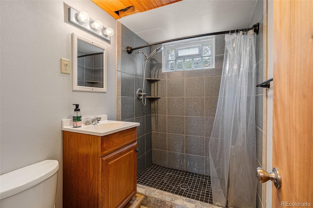 bathroom with toilet, vanity, and a shower with shower curtain