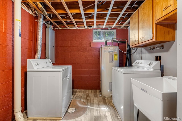 laundry room with separate washer and dryer, water heater, sink, and light wood-type flooring