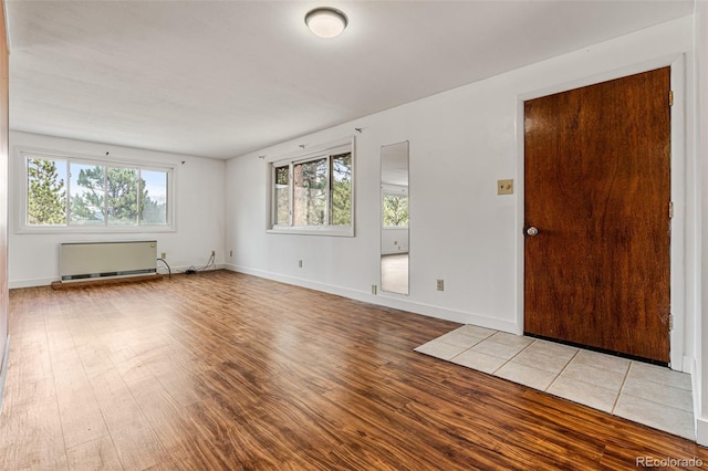 interior space featuring radiator and light wood-type flooring