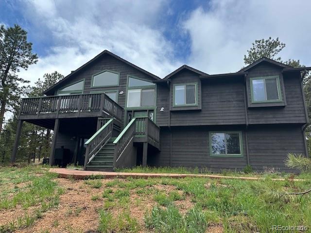 4041 Trout Creed Rd, Woodland Park, CO 80863 - back of property with a wooden deck and stairs