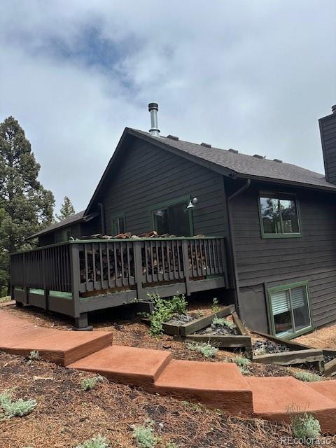 4041 Trout Creed Rd, Woodland Park, CO 80863 - back of house featuring a chimney and a deck