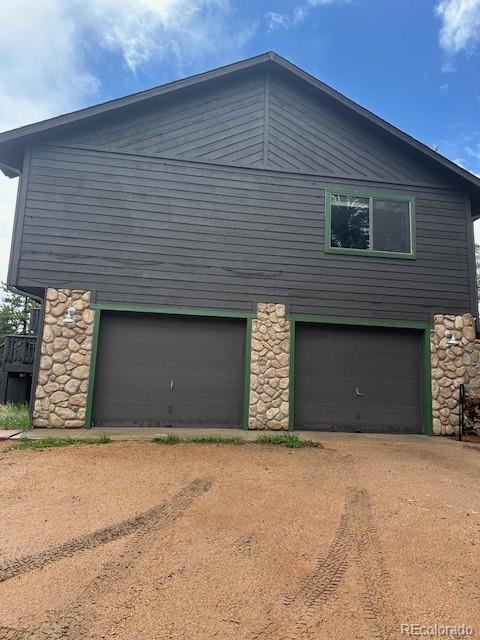 4041 Trout Creed Rd, Woodland Park, CO 80863 - view of property exterior featuring stone siding and driveway