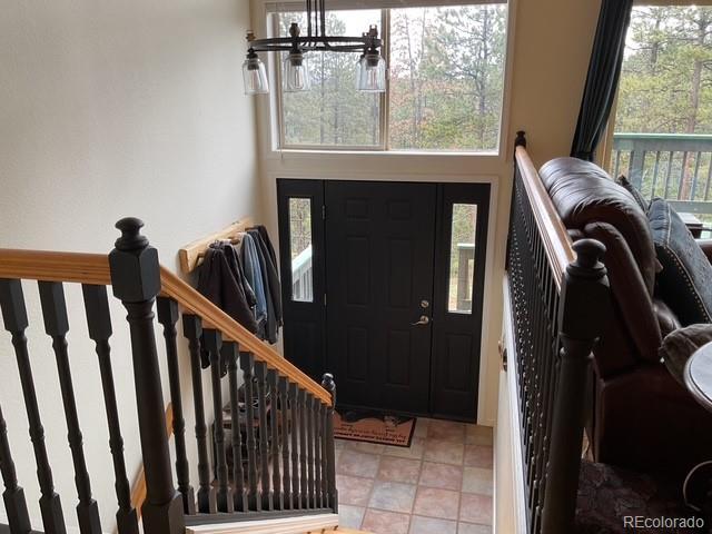 4041 Trout Creed Rd, Woodland Park, CO 80863 - entrance foyer featuring a chandelier