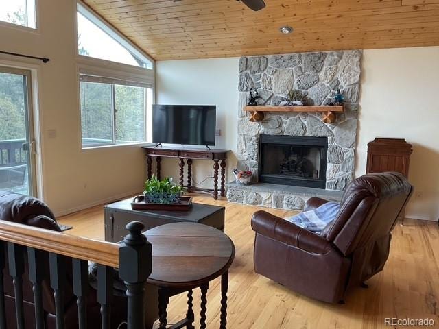 4041 Trout Creed Rd, Woodland Park, CO 80863 - living area with wooden ceiling, a stone fireplace, lofted ceiling, wood finished floors, and baseboards