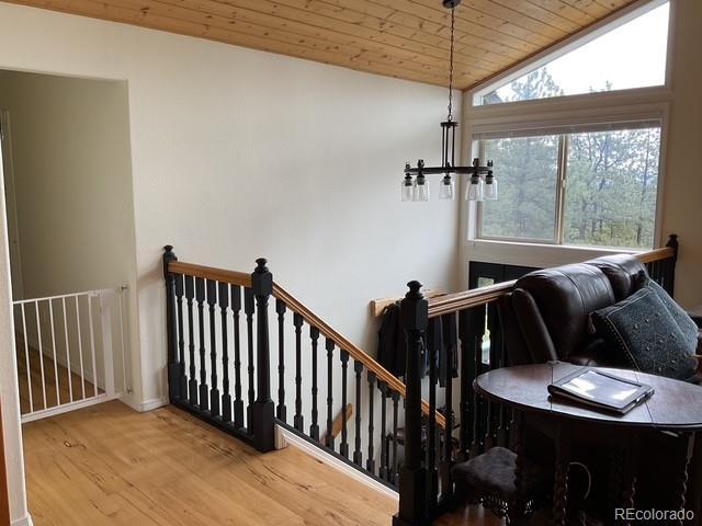 4041 Trout Creed Rd, Woodland Park, CO 80863 - stairs featuring wood finished floors, wooden ceiling, and vaulted ceiling