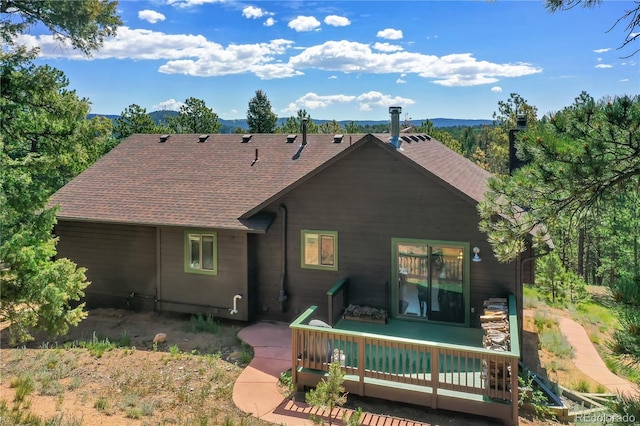 4041 Trout Creed Rd, Woodland Park, CO 80863 - rear view of house with a deck with mountain view and roof with shingles