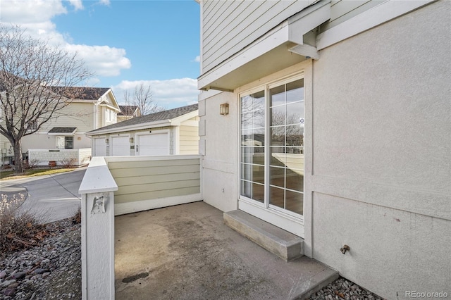 view of patio / terrace with a garage and an outdoor structure