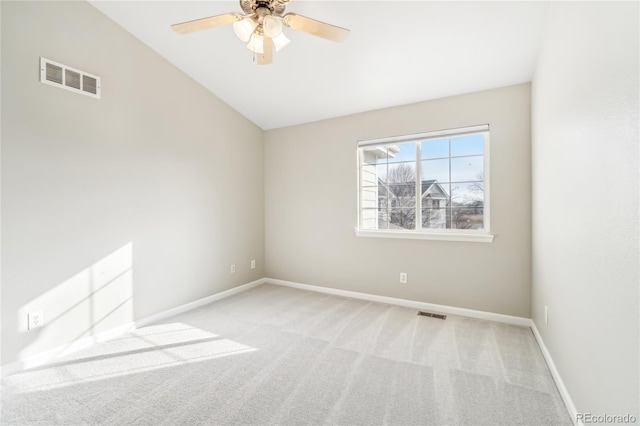 carpeted empty room with ceiling fan and lofted ceiling